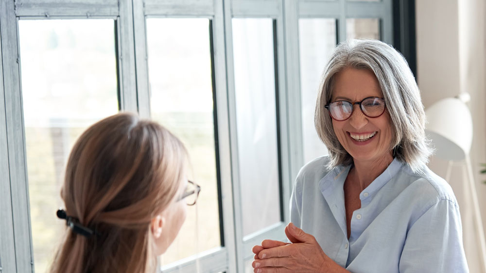 Older woman explaining concept to employee